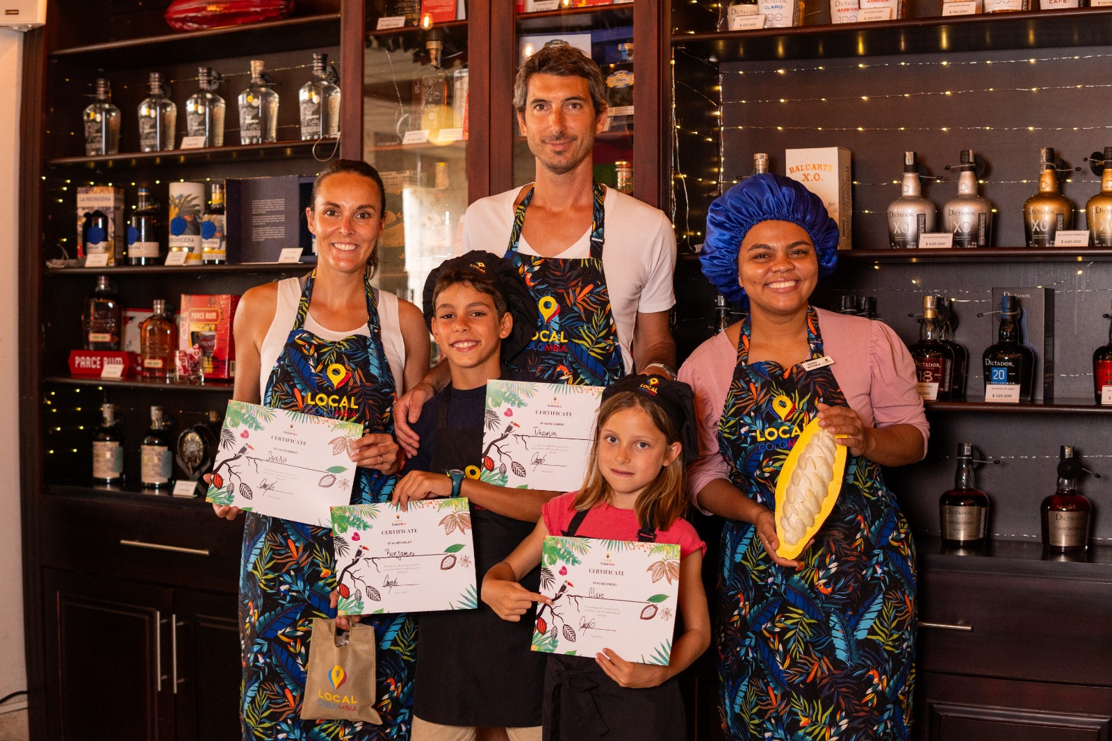 Family showing certificates after chocolate workshop in Cartagena Colombia
